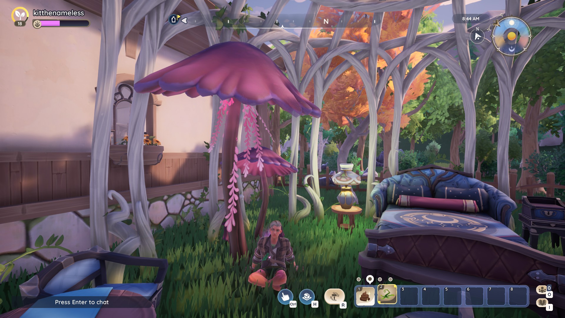 Palia screenshot of my character sitting on the ground in a gazebo that's made of twisting white branches. He's under some giant purple mushrooms that are in the gazebo. There's also a blue and purple, a blue chair, a fancy lamp, and a small table with a blue cloth. Sort of magical vibes.