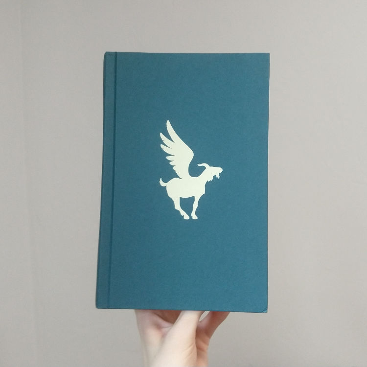 Any Way the Wind Blows by Rainbow Rowell - Naked hardcover is dark teal with a white silhouette of a winged goat