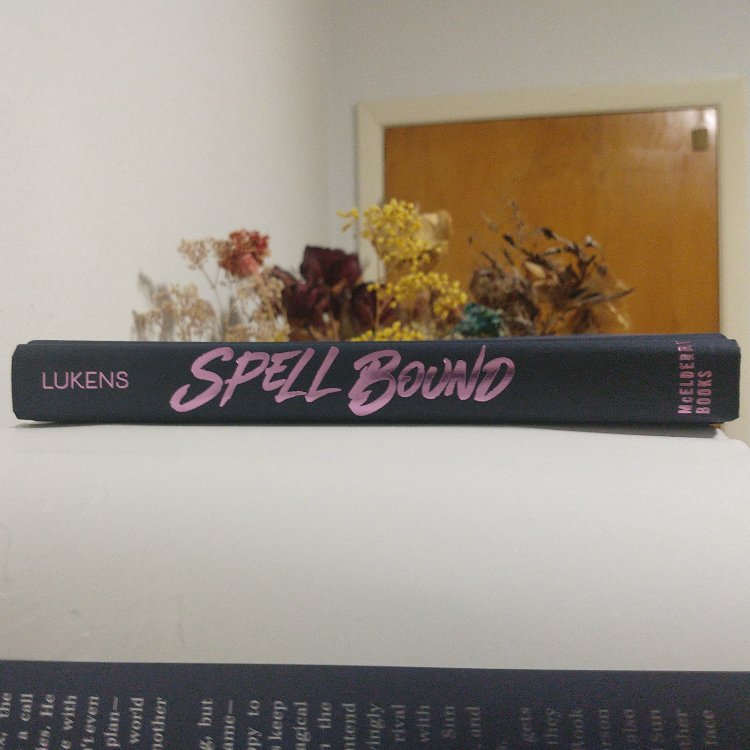 Spell Bound by FT Lukens spine with no dust jacket. It's dark blue with the title, author, and publisher in pink lettering.
